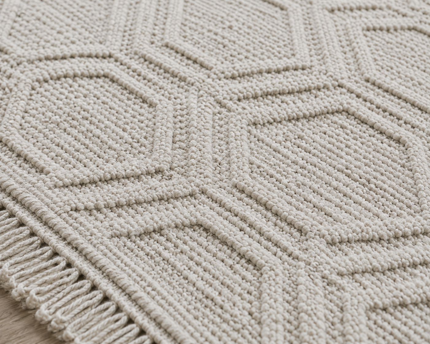 Close-up of a textured beige rug with geometric pattern